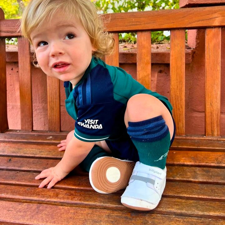 A happy toddler wearing Billycart Kids Brooklyn soft sole white sneakers