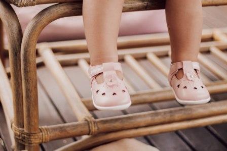 A toddler wearing Billycart Kids Rosie Pink Stylish prewalker soft sole pink Tbar sneakers